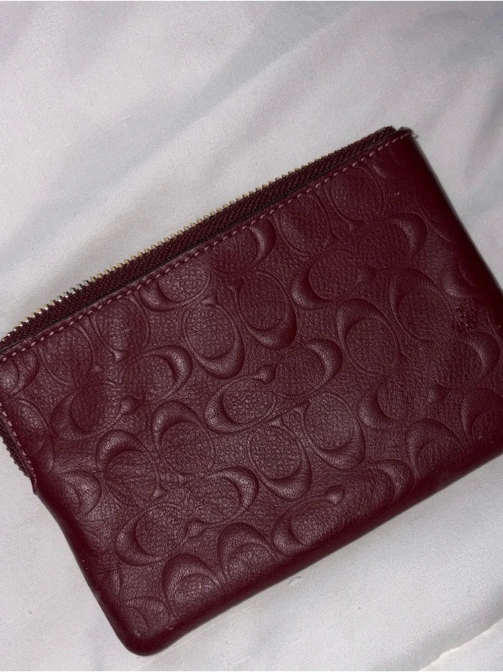 COACH Embossed Signature Wristlet in burgundy with Gold Logo, used once